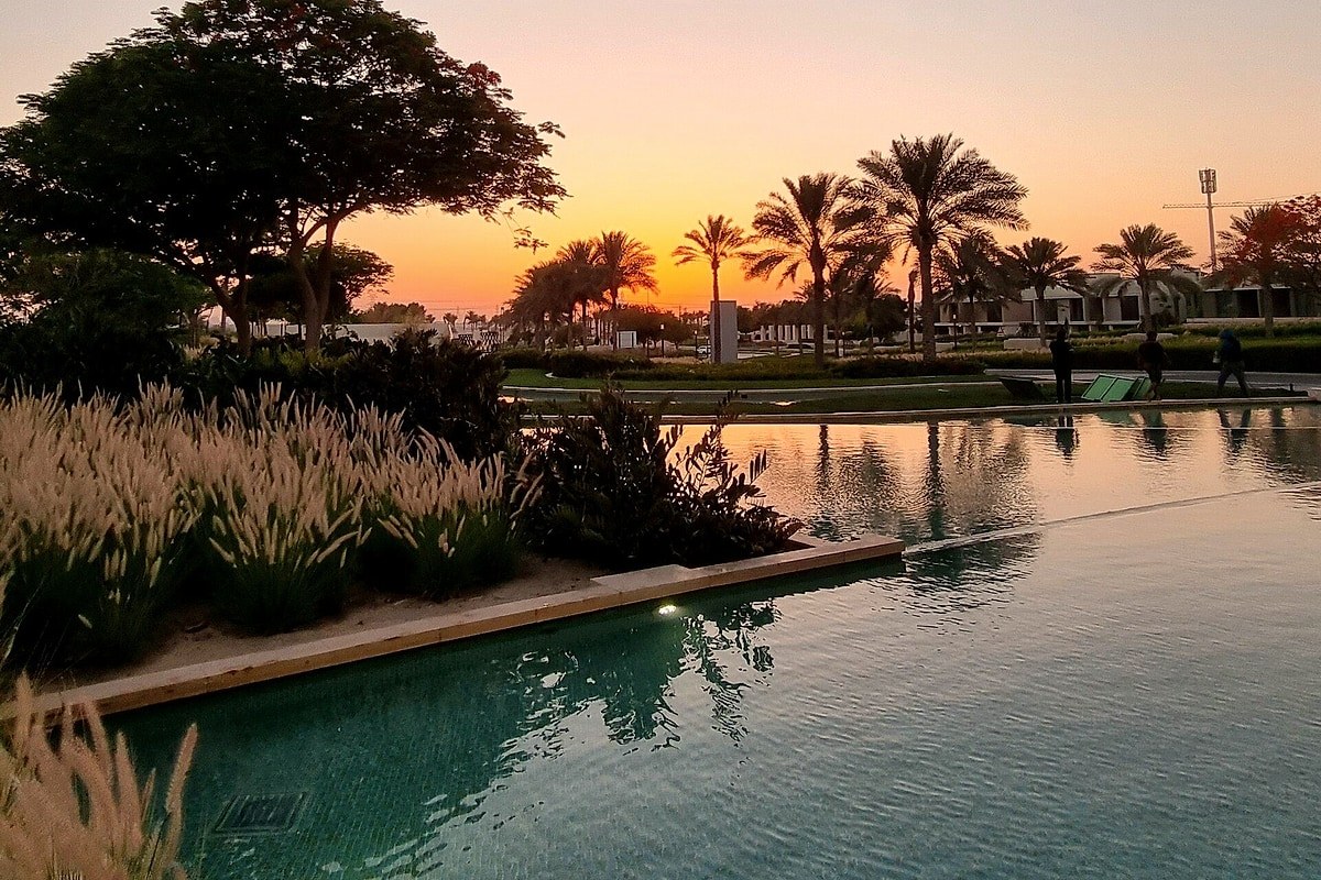 Palms and a lake in Dubai Hills at sunset